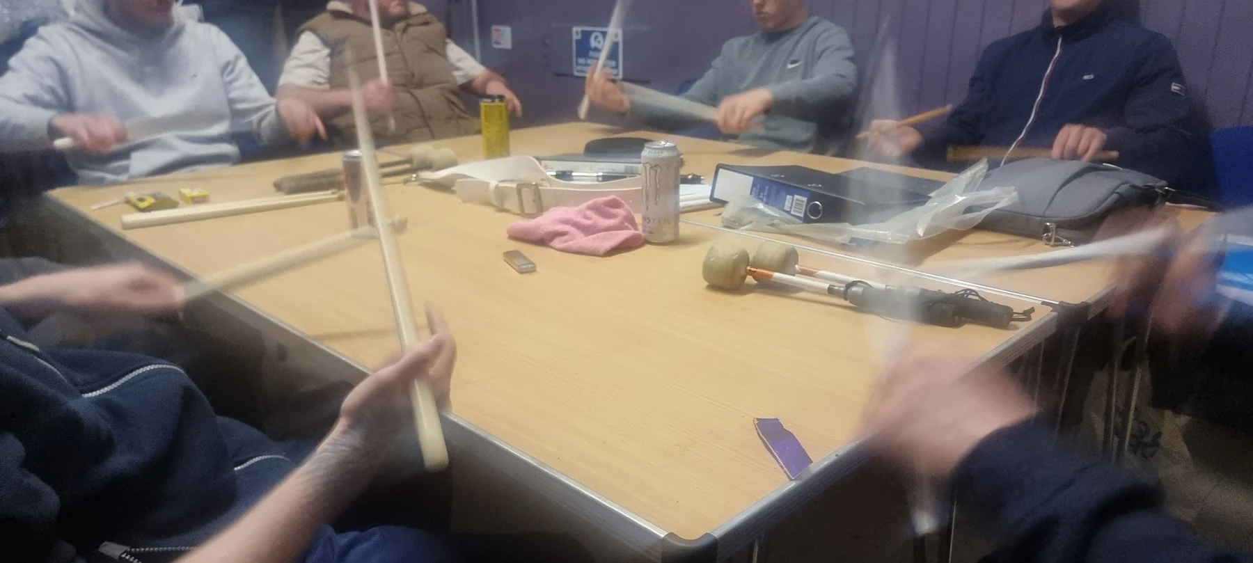 Participants taking part in a drumming tuition session
